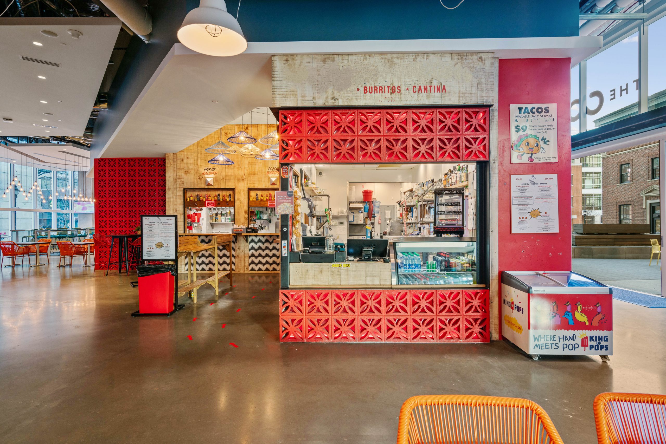 Ordering counter for quick service restaurant located in Atlanta Food Hall with bright colors in a modern setting.