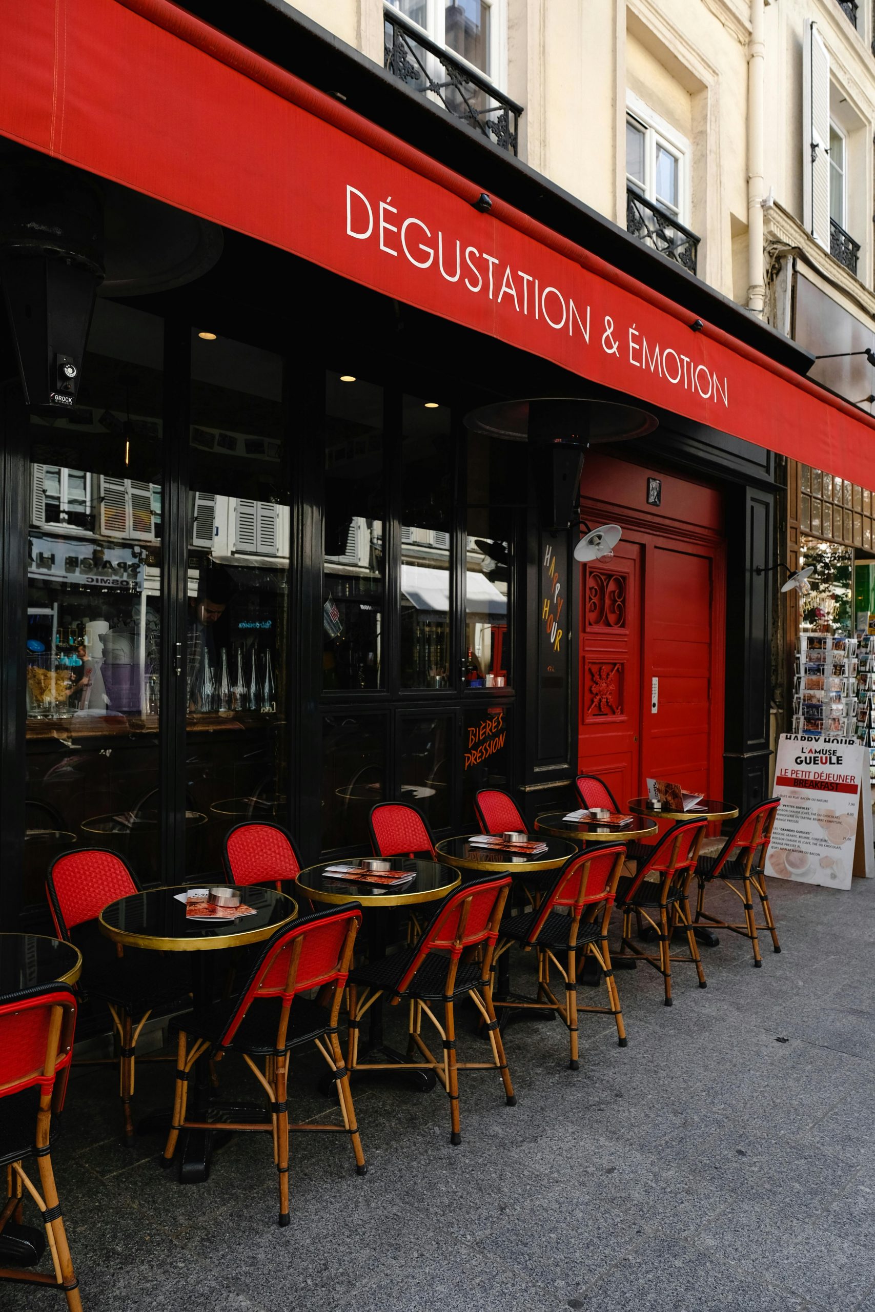 French Bistro with colorful red chairs in outside seating area.