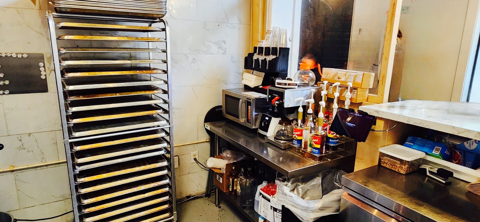 Coffee preparation area with cookie sheet pans next to it