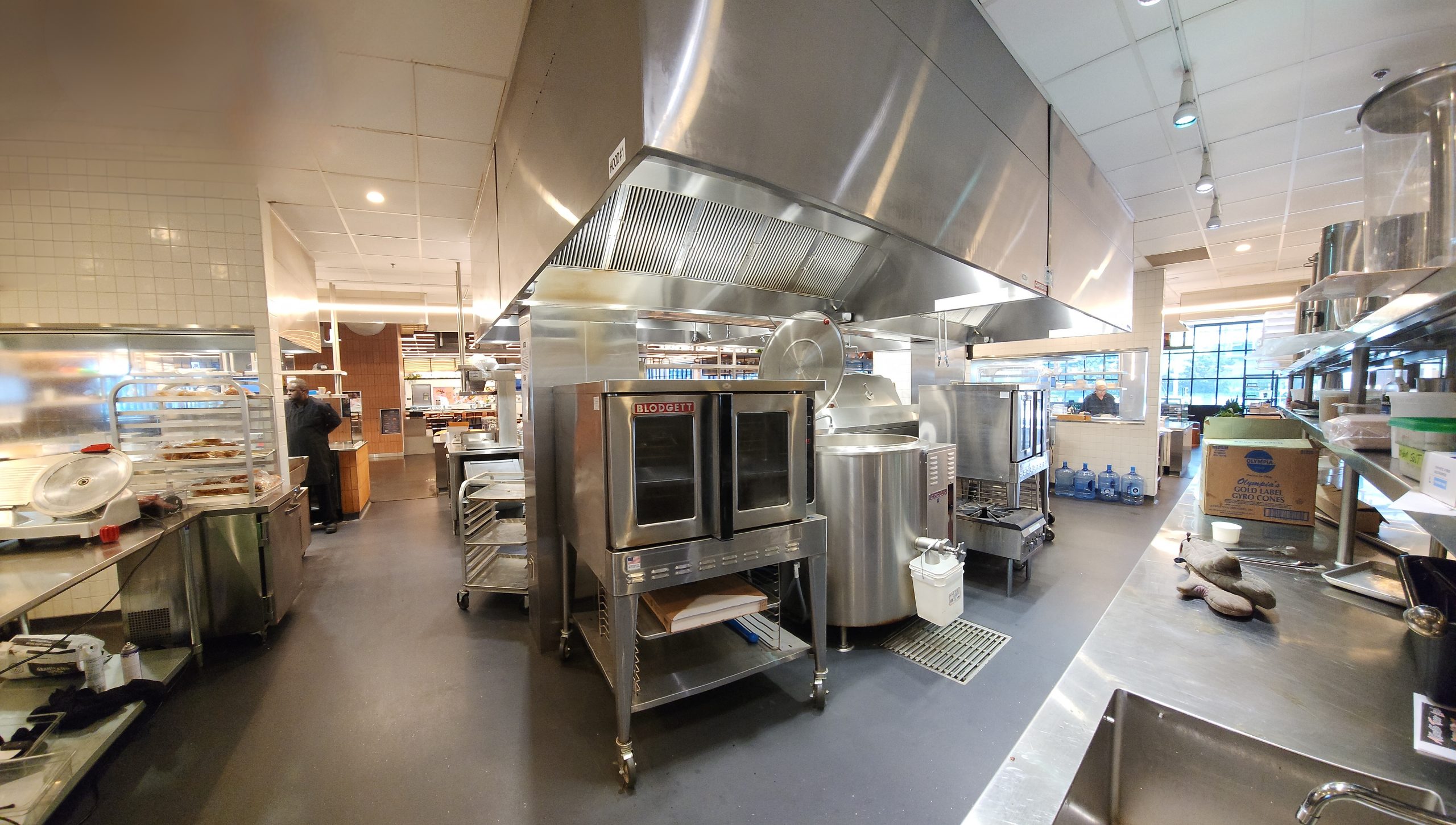 Commercial Kitchen with large hood, convection ovens and kettle. Opportunity for chefs and restaurant owners