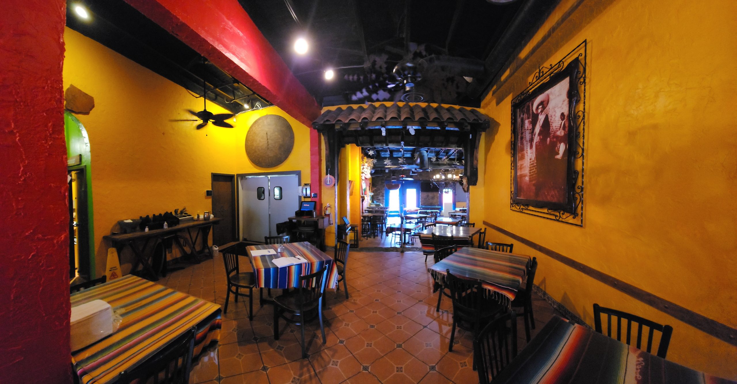 Mexican restaurant seating area with bright yellow and red colors listed by Jimmy Carey Commercial Real Estate in Atlanta