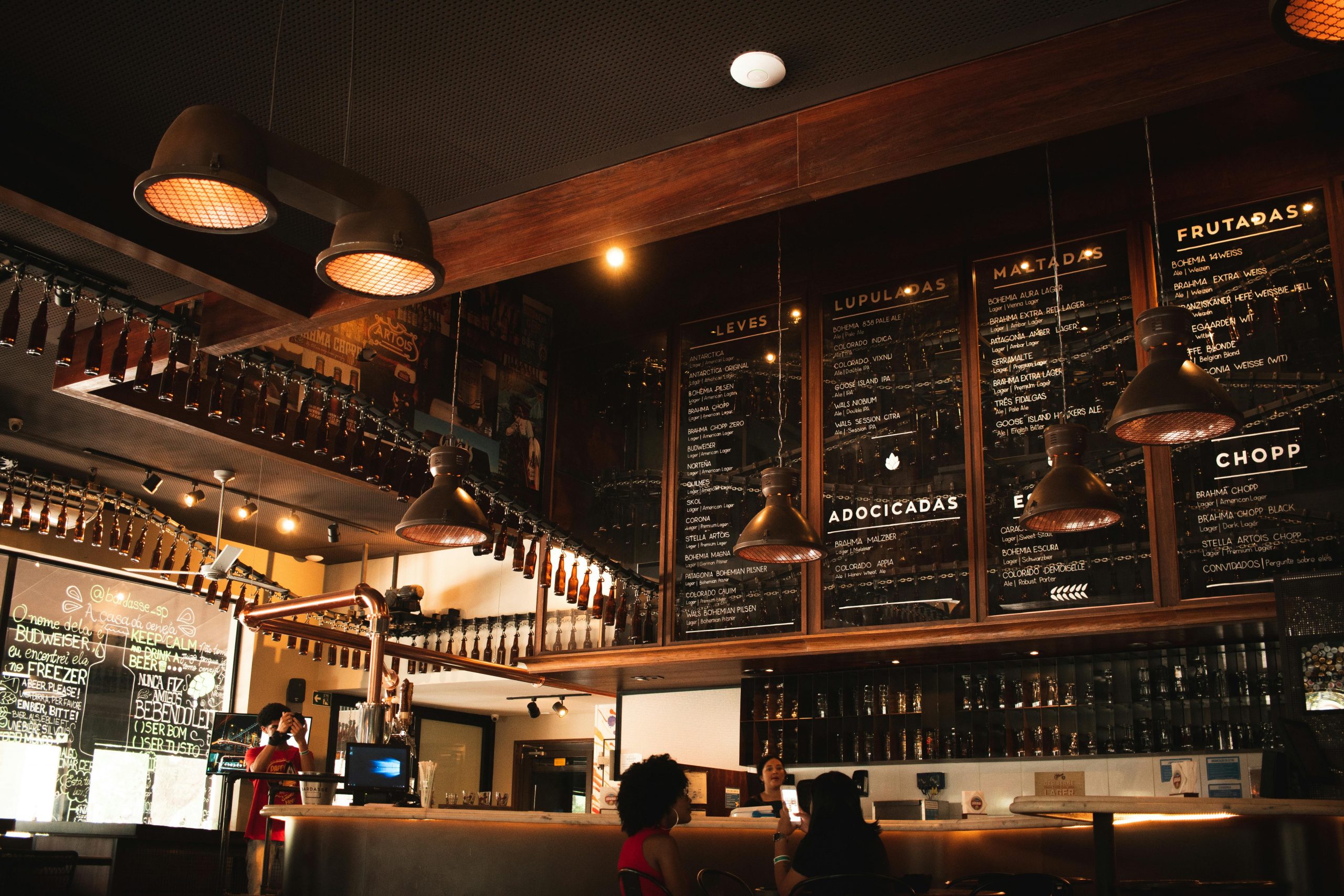 Restaurant Bar with tall ceilings and large menu chalk boards describing menu items and steaks