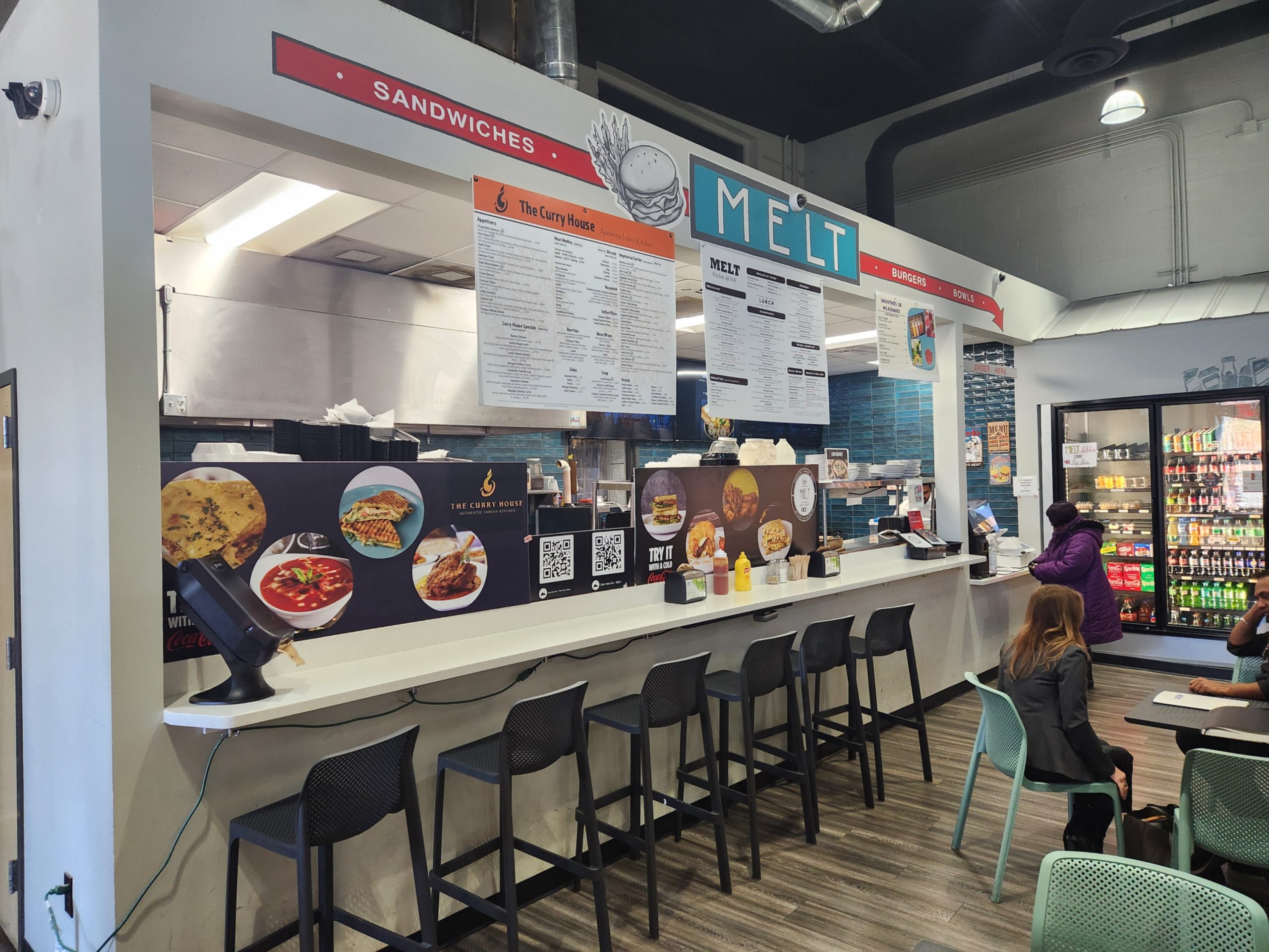 Kitchen counter in Old Fourth Ward, Indian Restaurant with high chairs in a casual setting sold by the Jimmy Carey Commercial Real Estate Team.