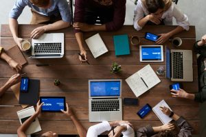 Business owners having a meeting in a large table with open computers 