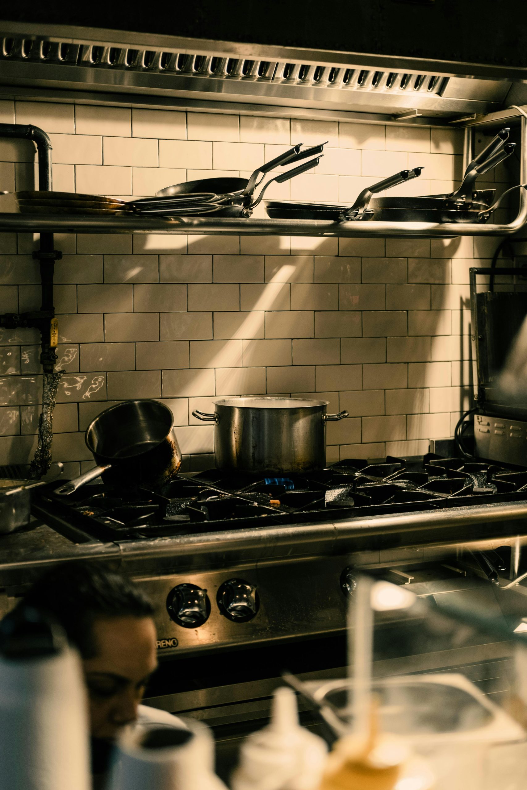 Commercial restaurant Kitchen with pots and pans on a gas stove with mise en place