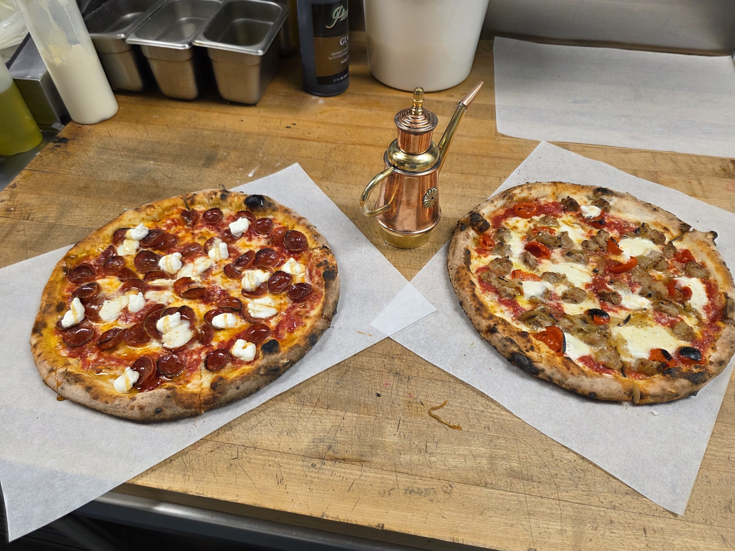 Pepperoni Hot Honey and La Passione pizzas at Char Pizzeria Halcyon, crafted by Chef John Frank Cely and represented by Jimmy Carey Commercial Real Estate, Atlanta’s Premier Restaurant Broker specializing in Restaurant Tenant Representation Atlanta.