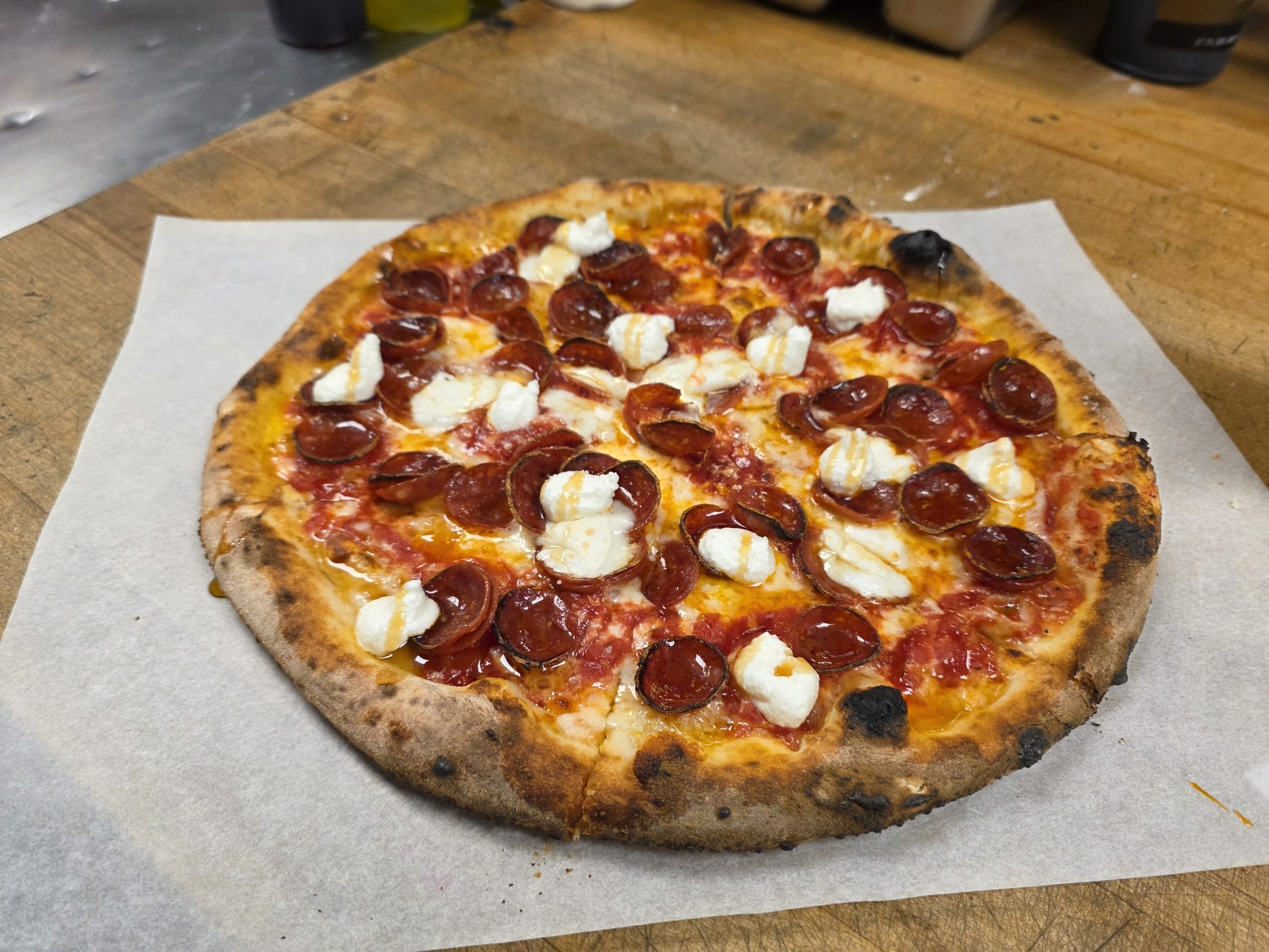 Pepperoni Hot Honey Pizza at Char Pizzeria Halcyon, crafted by Chef John Frank Cely and represented by Jimmy Carey Commercial Real Estate, Atlanta’s Premier Restaurant Broker specializing in Restaurant Tenant Representation Atlanta.